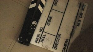 A close up of a movie clapper on the ground